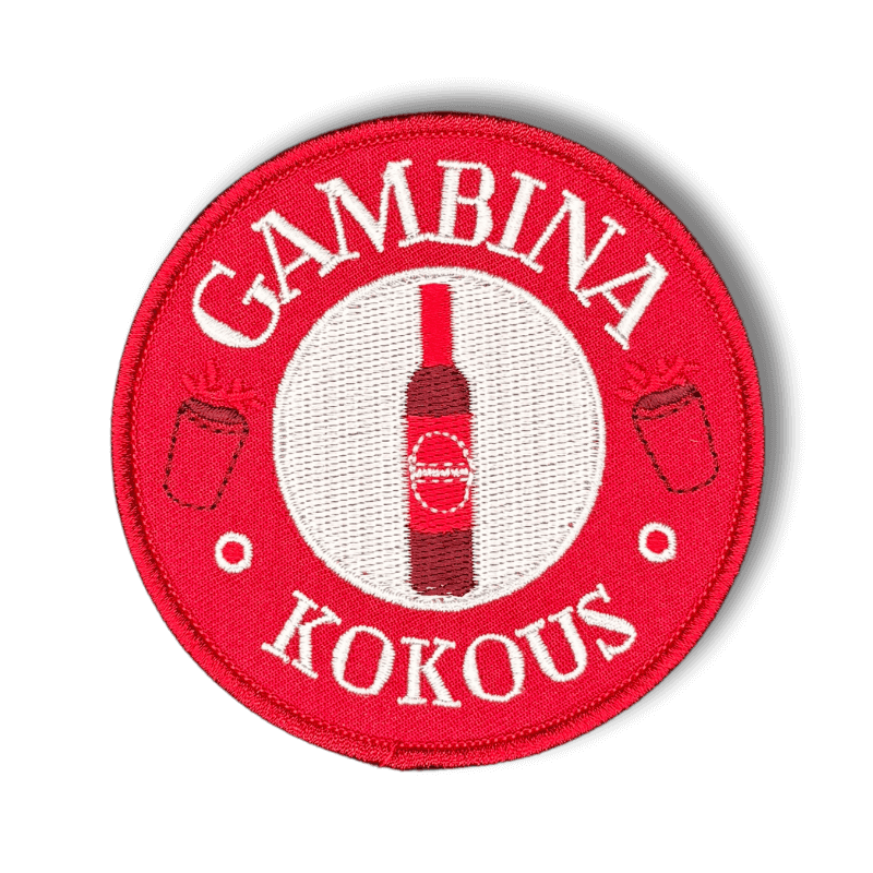 Brodeerattu haalarimerkki Gambina pullosta saumatulla reunalla ja tekstillä: ''Gambina kokous''