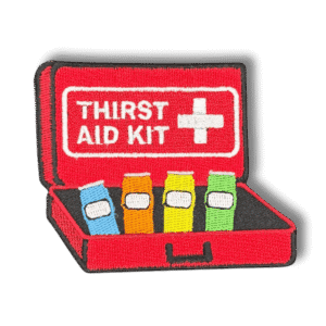 Brodeerattu haalarimerkki ensiapupakkauksesta saumatulla reunalla, tekstillä: ''Thirst Aid Kit''